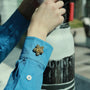 Astral Flora gold button cover on sleeve