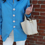 close up shoot for Astral_flora pearl button cover in a blue shirt