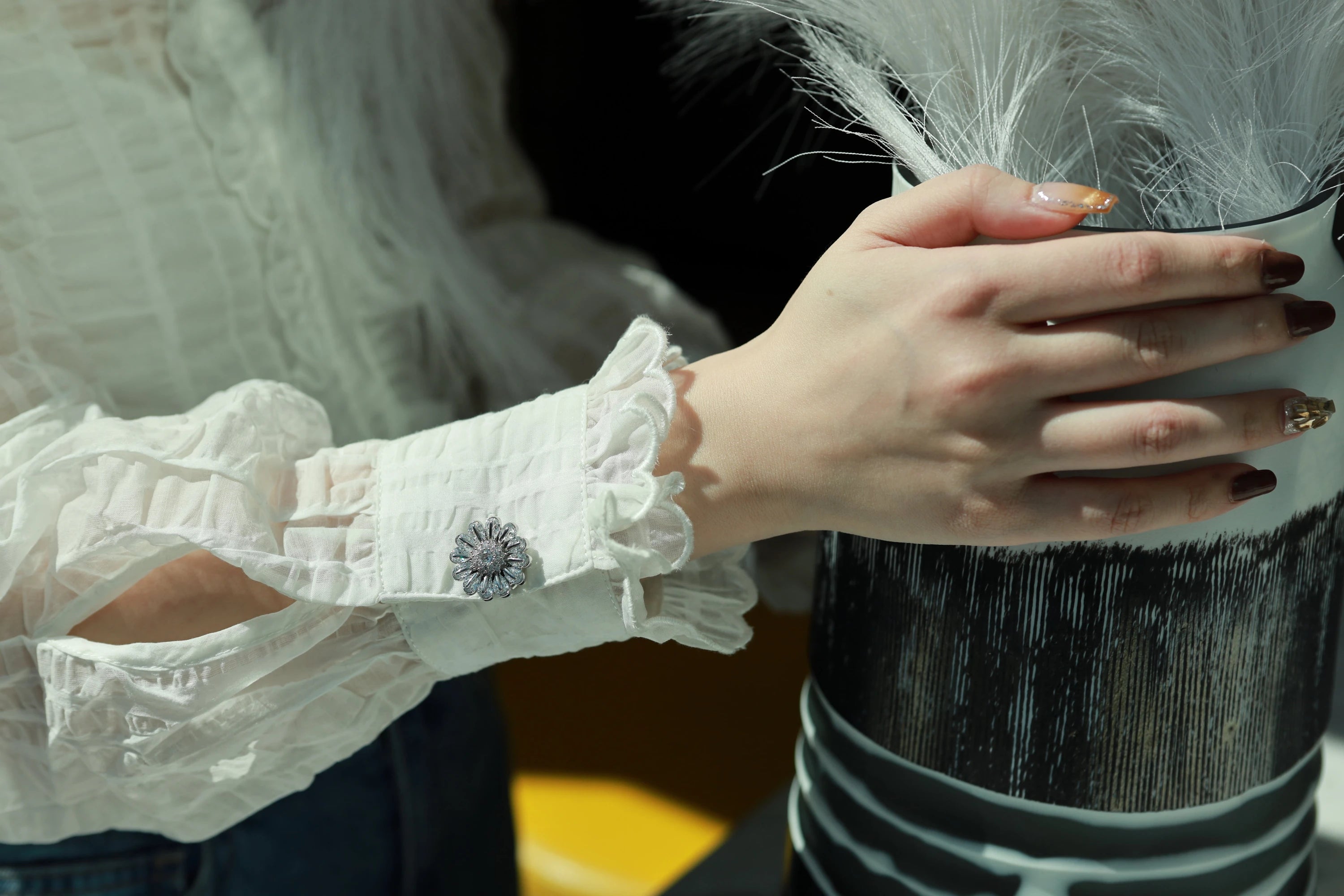Aurelian Petal attached to a shirt cuff button.
