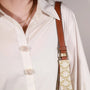 Close-up of a person wearing a white button-up shirt and cloud bouquet flower button covers