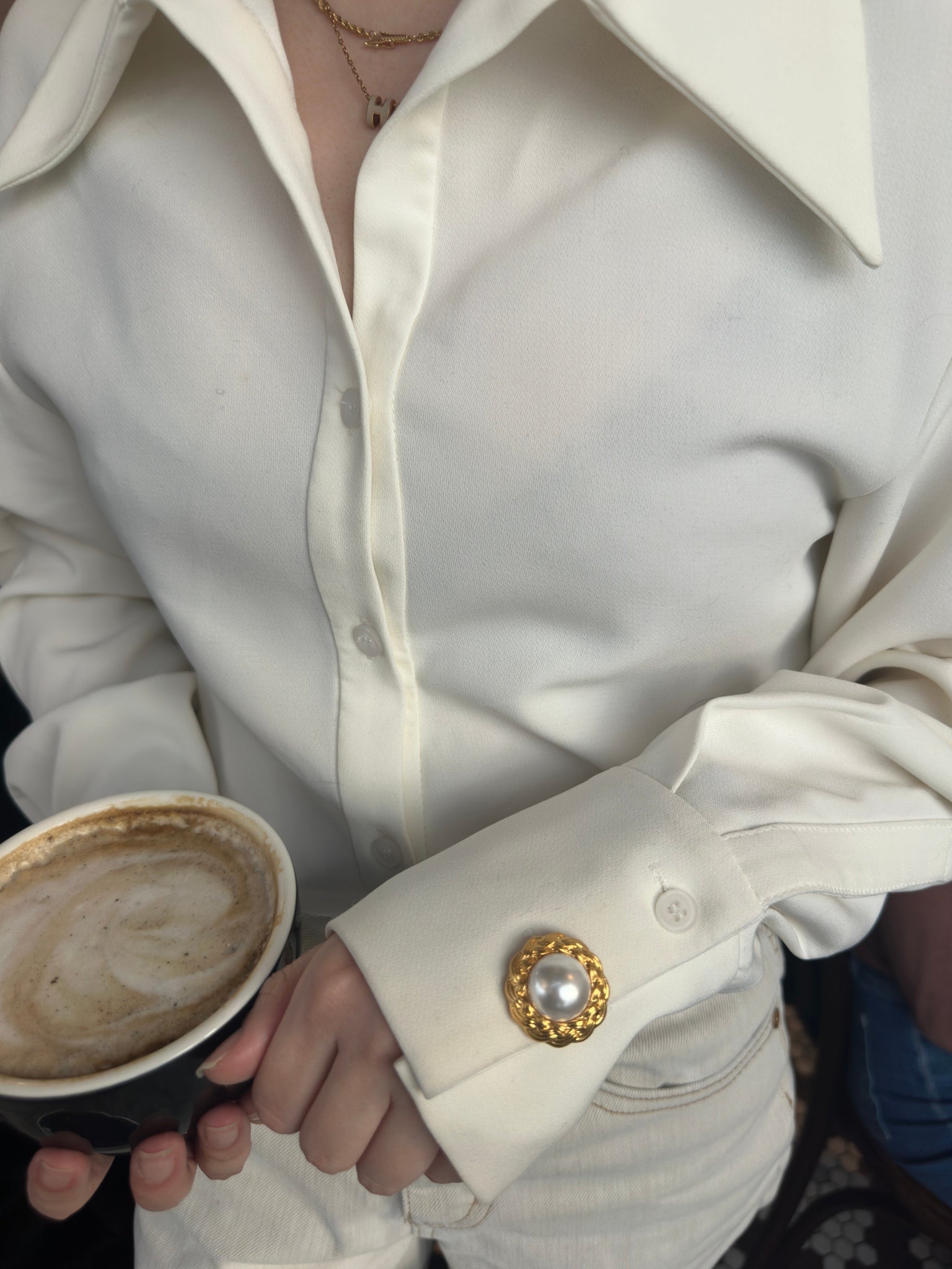Riviera Pearl 22K gold-plated braided clip-on button cover with a central pearl on sleeve