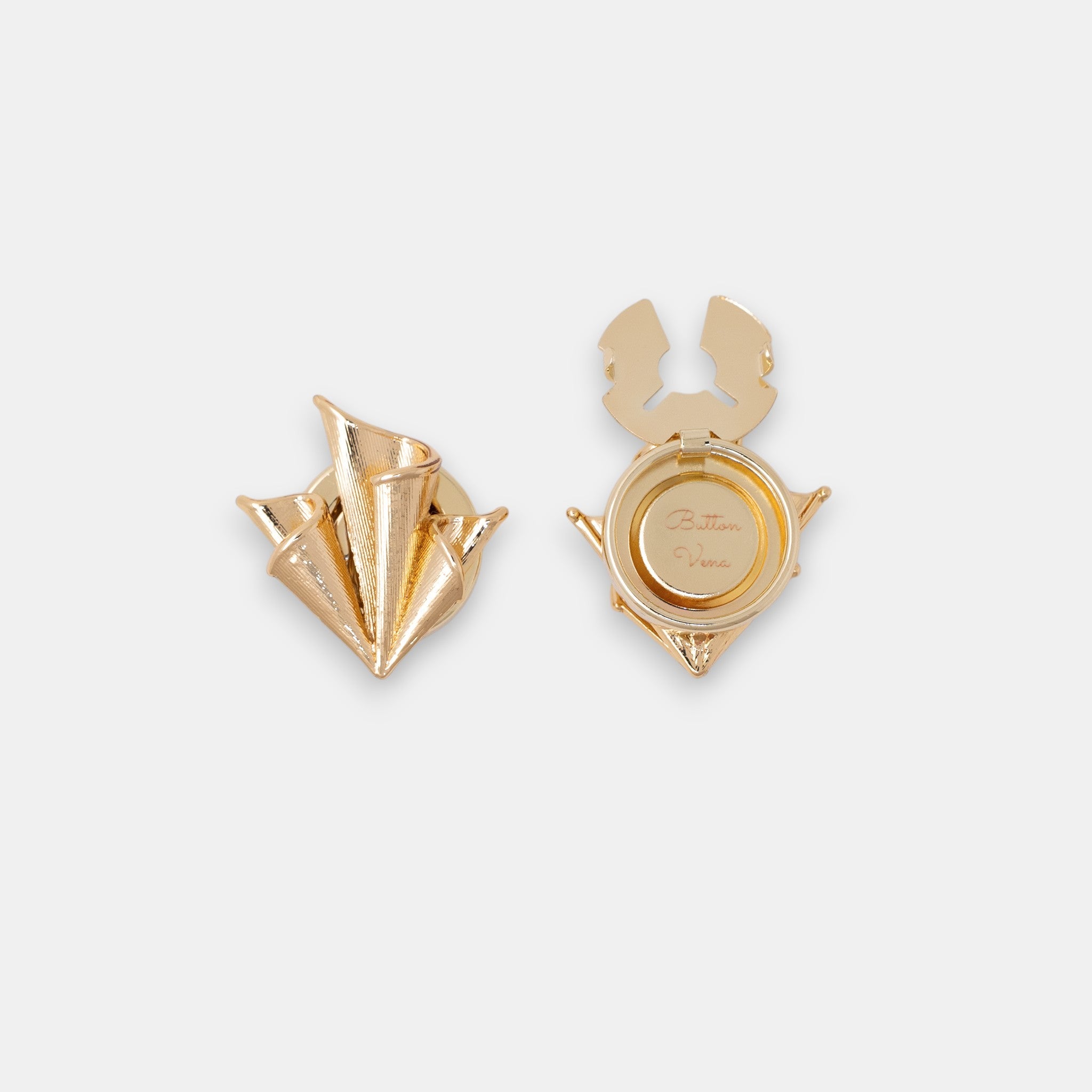 The Foulard 22K gold-plated clip-on button cover featuring architectural silk-inspired folds.