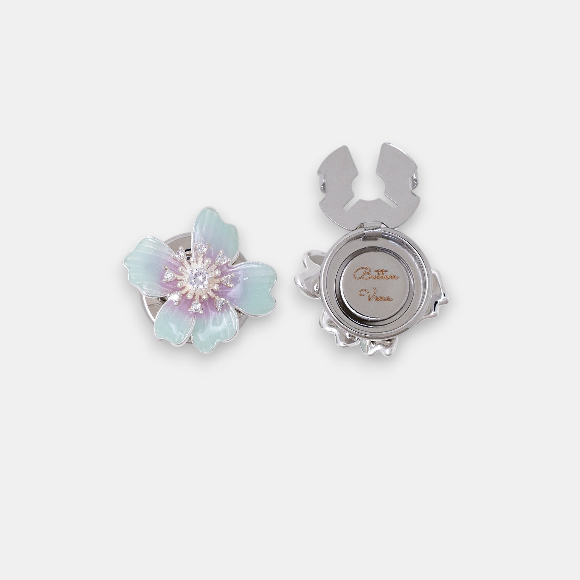 The Iris floral clip-on button cover with hand-painted teal and violet enamel and a brilliant zirconia center