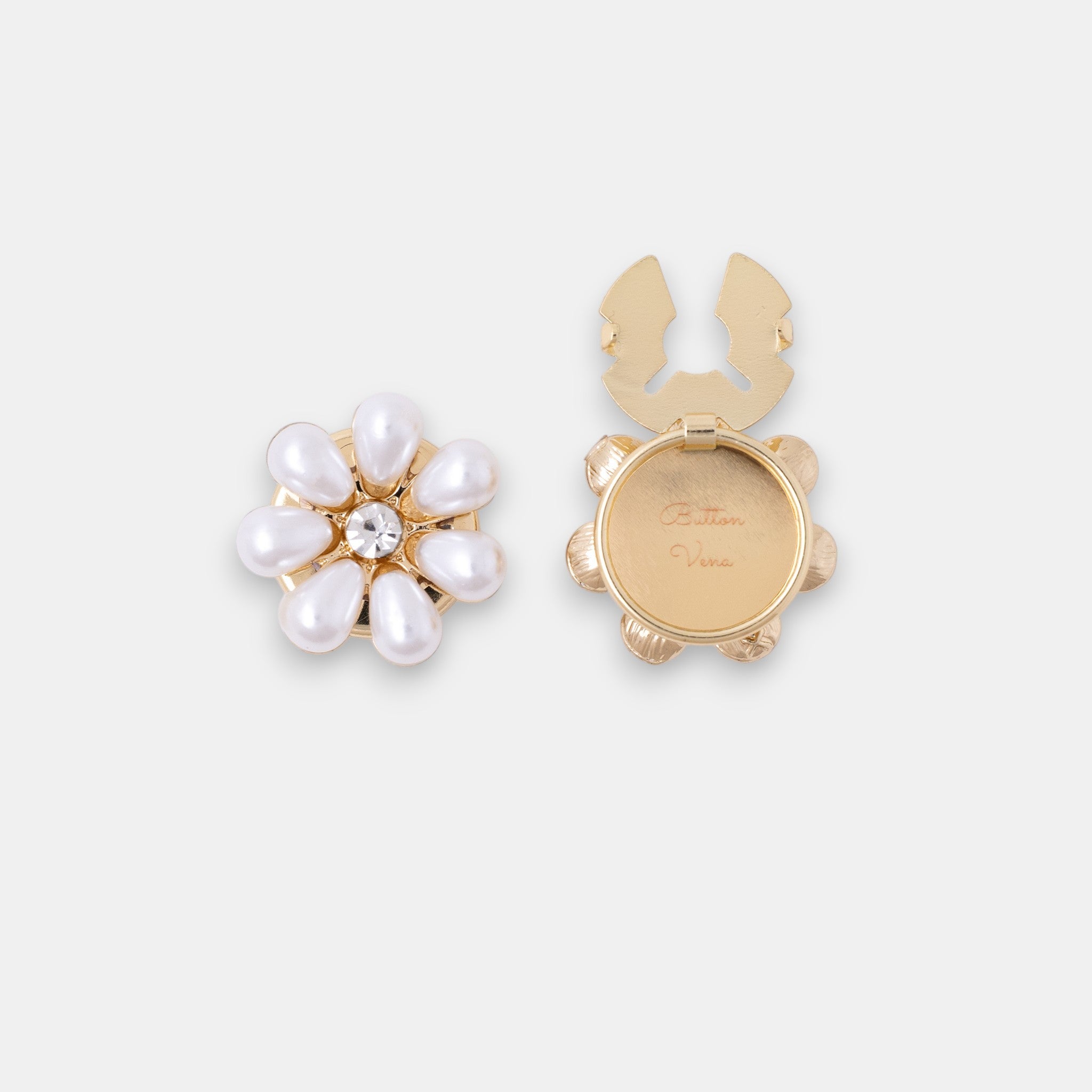 The Maya gold seven-petal teardrop pearl clip-on button cover with a rhinestone center