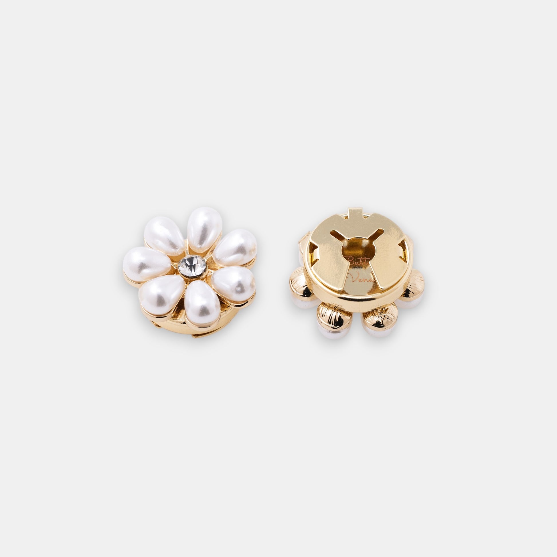The Maya gold seven-petal teardrop pearl clip-on button cover with a rhinestone center side