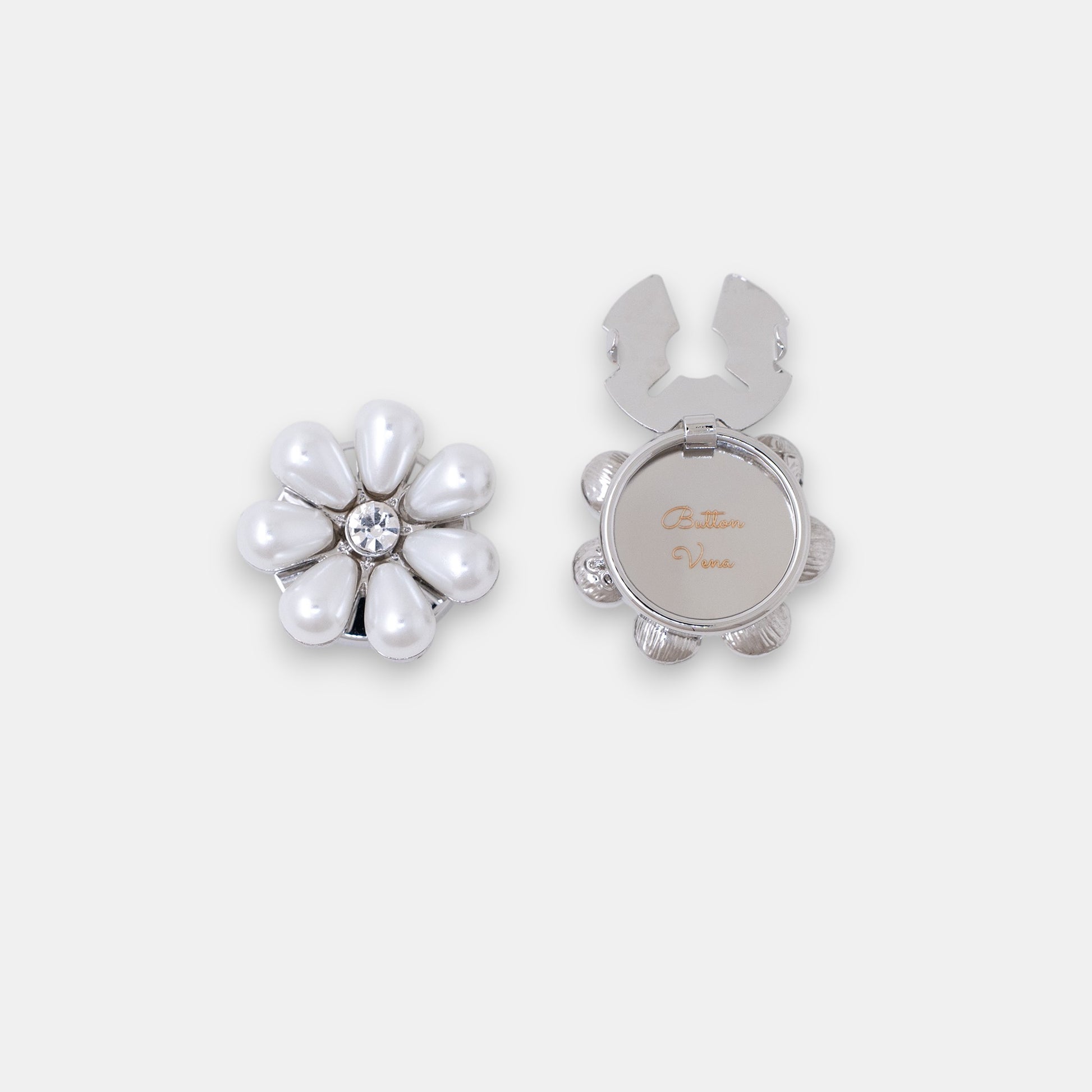 The Maya silver seven-petal teardrop pearl clip-on button cover with a rhinestone center