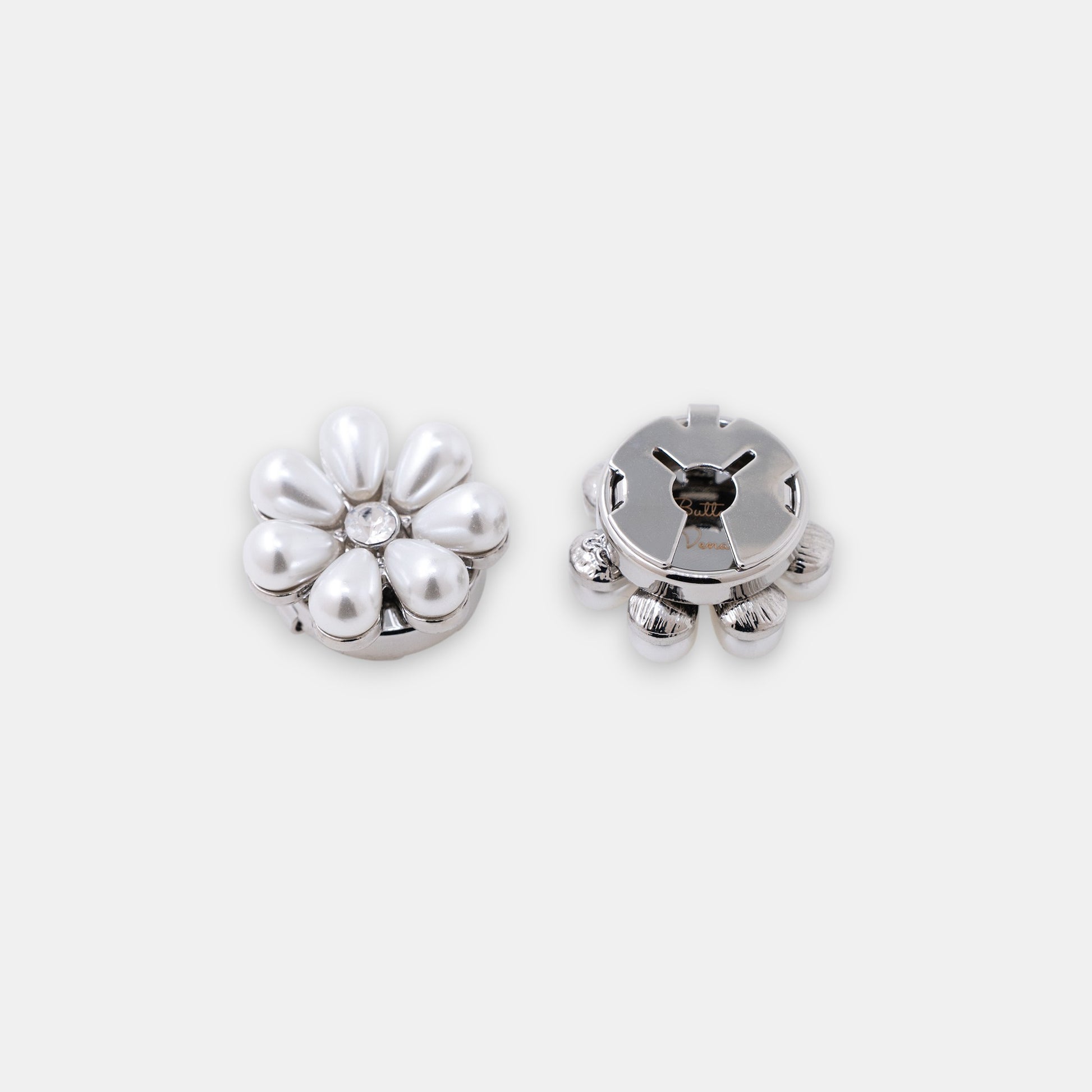 The Maya silver seven-petal teardrop pearl clip-on button cover with a rhinestone center side